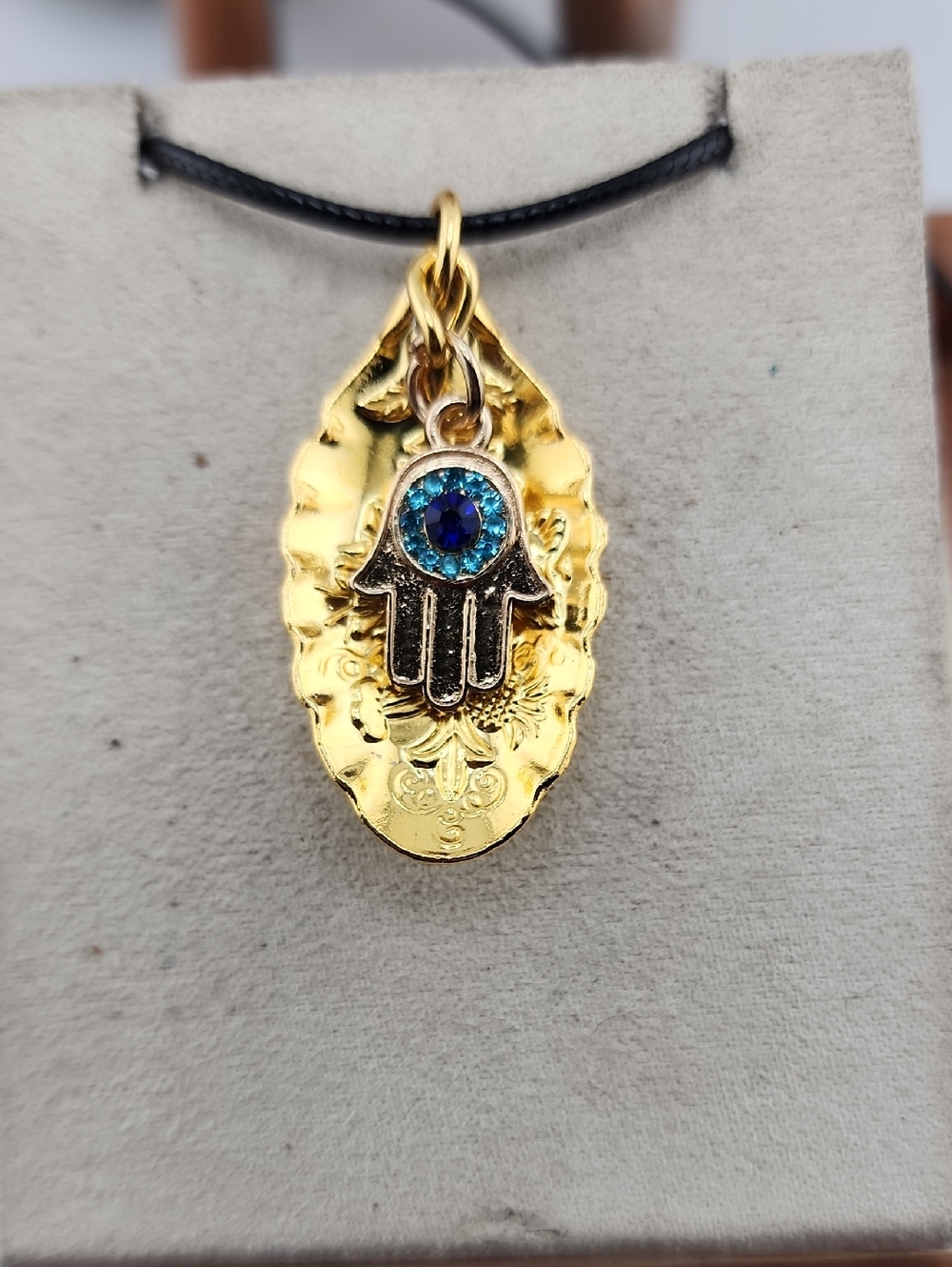 Gold Hamsa Hand Necklace with Blue Crystal Accent
